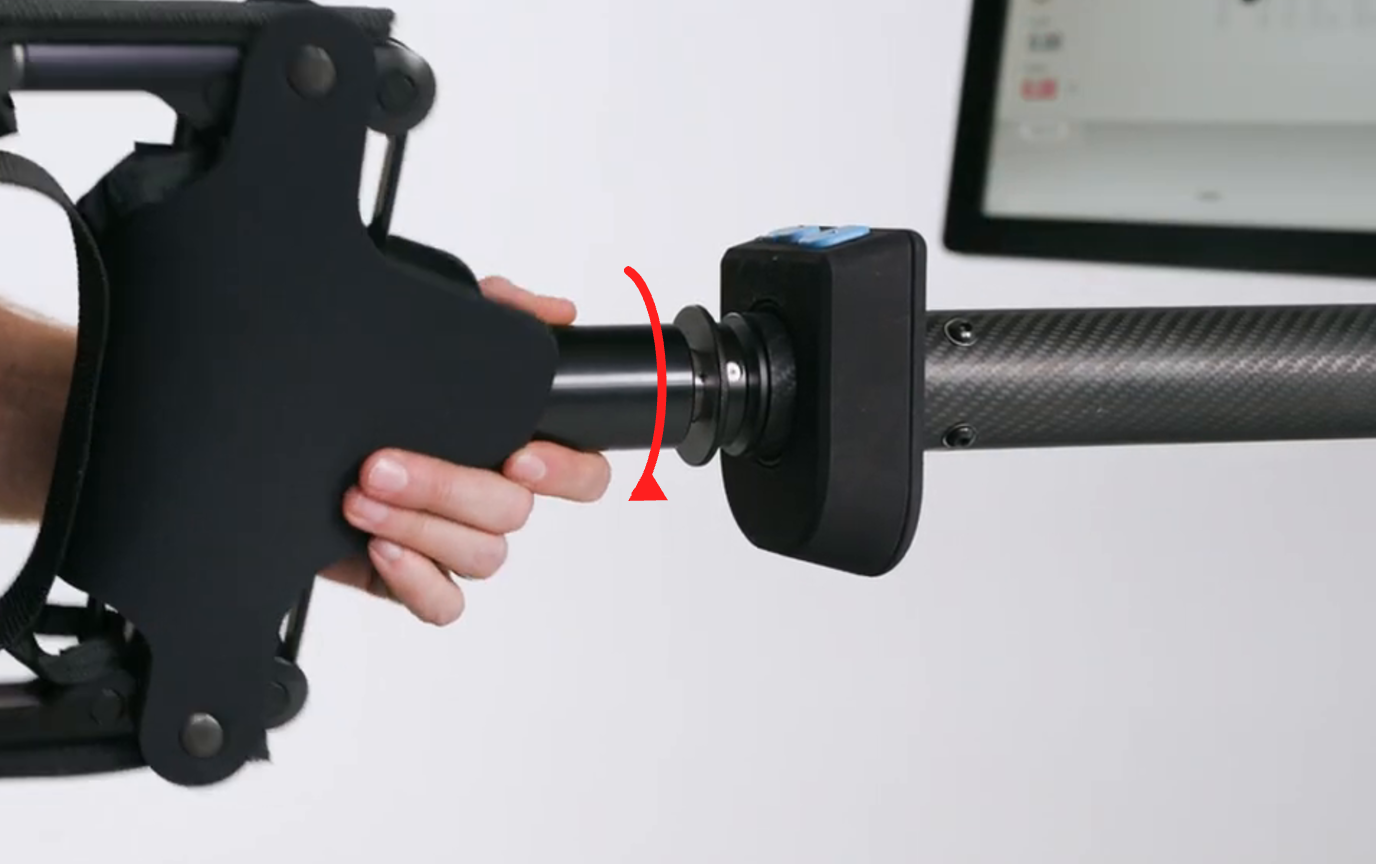 Hand on the handle base with a curved arrow showing twist